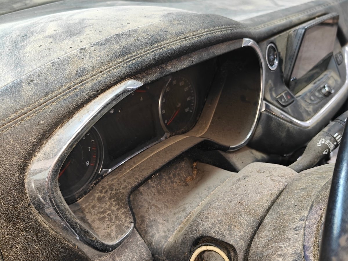 Gauge cluster and dash caked in heavy dust before detailing