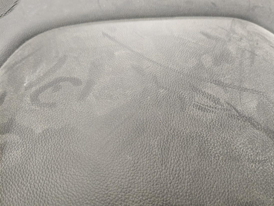 Heavily stained vehicle seat before deep shampoo and extraction
