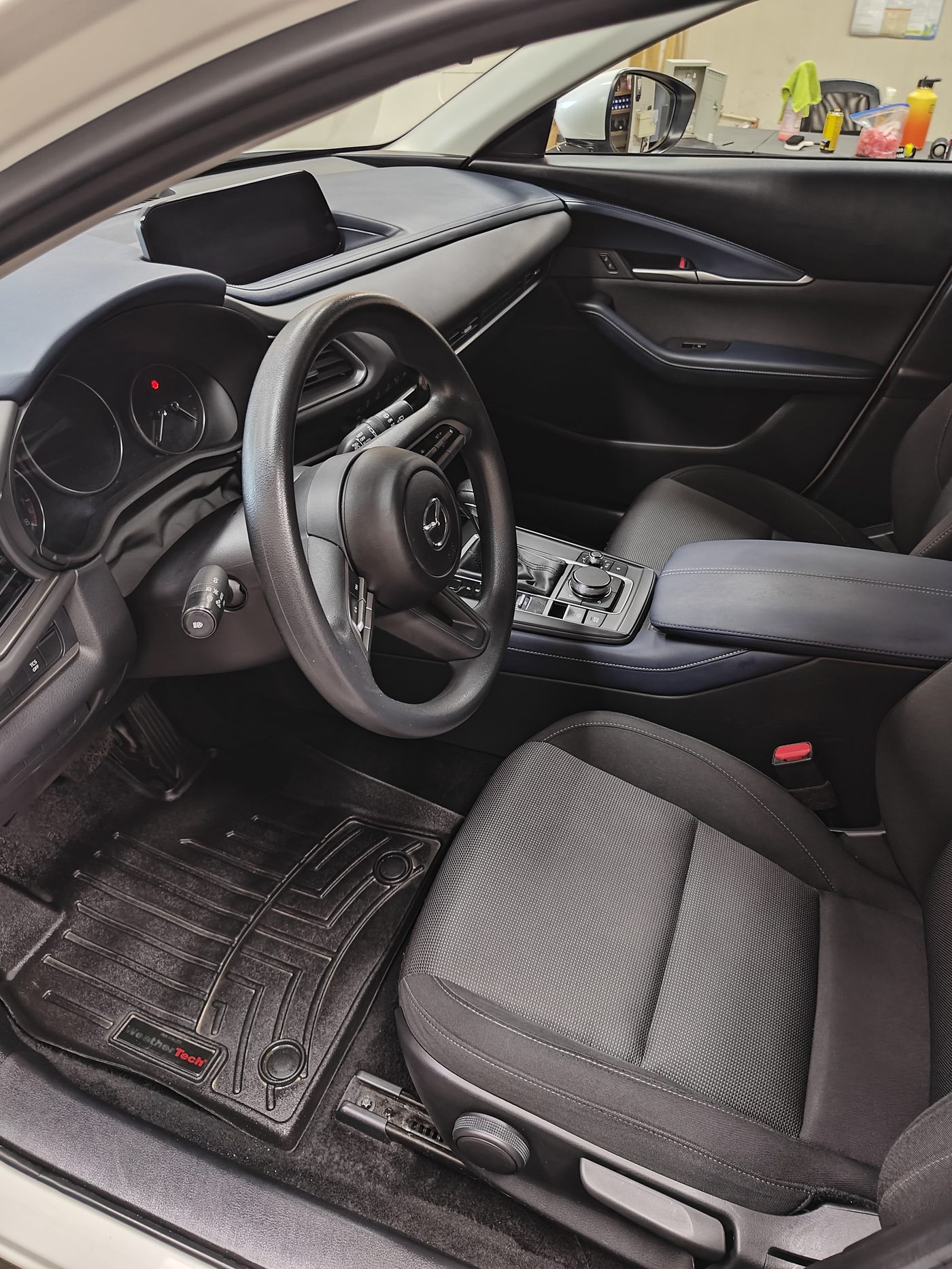 Clean black Mazda interior with conditioned seats and dashboard